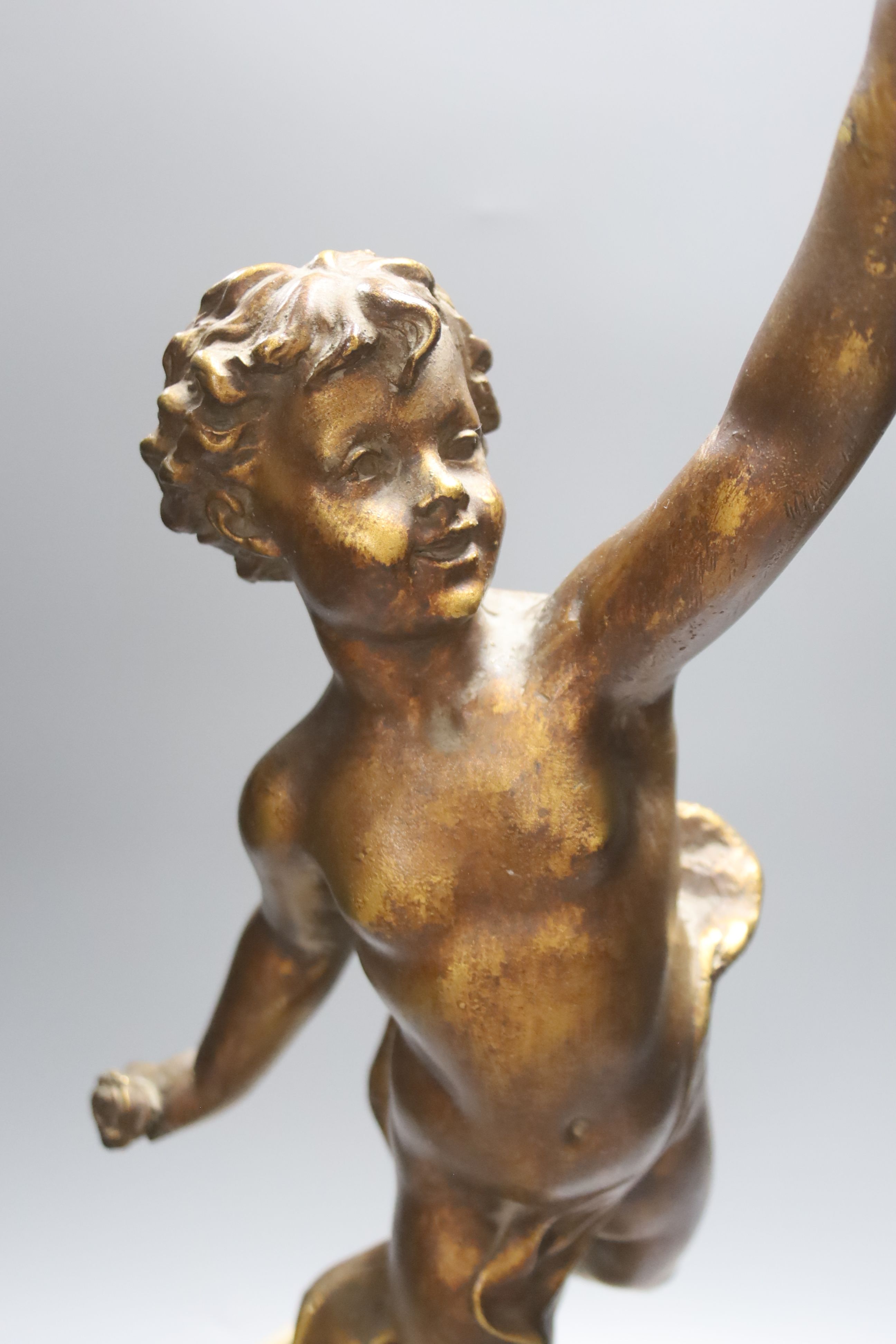 A patinated figural table lamp